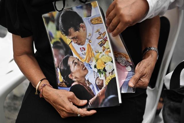 Mourners hold photos of Thai Princess Bajrakitiyabha Mahidol and her father Thai King Maha Vajiralongkorn inside Chulalongkorn Hospital in Bangkok on June 12, 2026. Thai Princess Bajrakitiyabha Mahidol, the king's eldest daughter, has died aged 47, the royal palace announced on June 12, more than three years after she was hospitalised following a sudden illness. (Photo by Lillian SUWANRUMPHA / AFP)