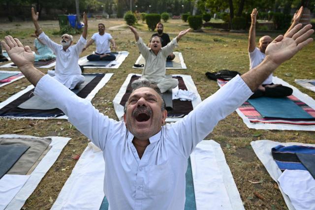 People perform yoga at a garden in Amritsar on June 12, 2026. (Photo by Narinder NANU / AFP)