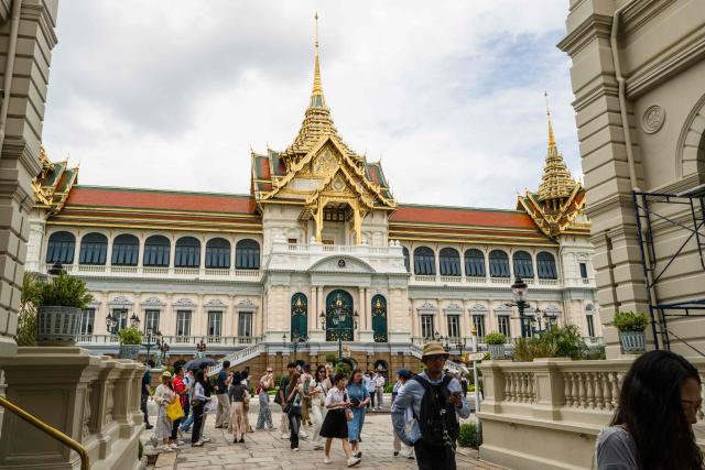 People visit the Grand Palace complex in Bangkok on June 12, 2026. Thai Princess Bajrakitiyabha Mahidol, the king's eldest daughter, has died aged 47, the royal palace announced on June 12, more than three years after she was hospitalised following a sudden illness. (Photo by ANTHONY WALLACE / AFP)