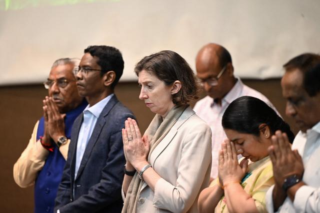 Lindy Cameron, British high commissioner to India, gestures during a prayer meeting in memory of Air India Flight 171 plane crash victims at BJ Medical College on the first anniversary of the disaster in Ahmedabad on June 12, 2026. India's aviation accident probe agency is facing renewed criticism from pilot groups ahead of the anniversary of the 2025 Air India Boeing-787 crash in Ahmedabad, which killed 260 people. (Photo by Shammi MEHRA / AFP)