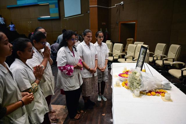Medical students attend a prayer meeting in memory of Air India Flight 171 plane crash victims at BJ Medical College on the first anniversary of the disaster in Ahmedabad on June 12, 2026. India's aviation accident probe agency is facing renewed criticism from pilot groups ahead of the anniversary of the 2025 Air India Boeing-787 crash in Ahmedabad, which killed 260 people. (Photo by Shammi MEHRA / AFP)