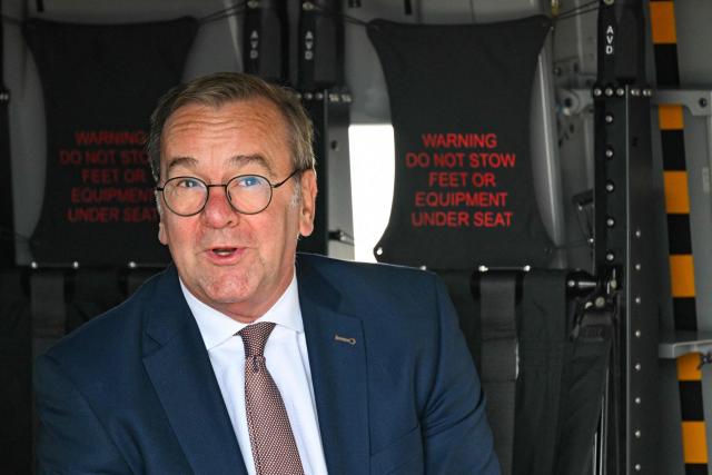 German Defence Minister Boris Pistorius sits in a NHIndustries NH90 twin-engine military helicopter of the German armed forces Bundeswehr as he tours the International Aerospace Exhibition (ILA) at the BER Airport in Schoenefeld, southeast of Berlin, on June 12, 2026. (Photo by RALF HIRSCHBERGER / AFP)