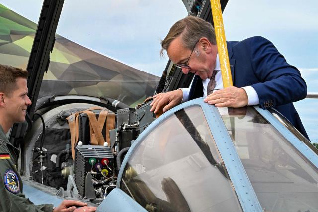 German Defence Minister Boris Pistorius inspects the cockpit of a tornado combat aircraft of the German armed forces Bundeswehr as he tours the International Aerospace Exhibition (ILA) at the BER Airport in Schoenefeld, southeast of Berlin, on June 12, 2026. (Photo by RALF HIRSCHBERGER / AFP)