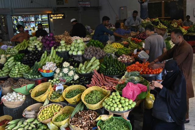 People buy vegetables at a market in Karachi on June 12, 2026. (Photo by Rizwan TABASSUM / AFP)