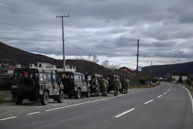 (FILES) Turkish soldiers, serving in a NATO  peacekeeping mission in Kosovo (KFOR), patrol near the town of Zubin Potok on December 2, 2024. NATO announced on June 12, 2026 that it was reducing the size of its military mission in Kosovo, KFOR, due to the “improvement” in security conditions in the small Balkan country. (Photo by Armend NIMANI / AFP)