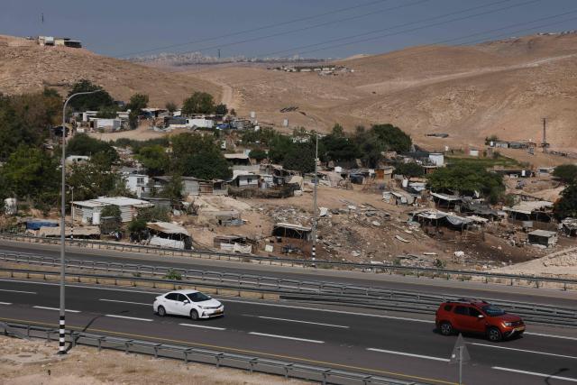 Vehicles drive past the Bedouin community of Khan al-Ahmar in the Israeli-occupied West Bank on June 12, 2026. Excluding east Jerusalem, more than 500,000 Israelis live in settlements in the West Bank, which Israel has occupied since 1967, among some three million Palestinians. (Photo by AHMAD GHARABLI / AFP)