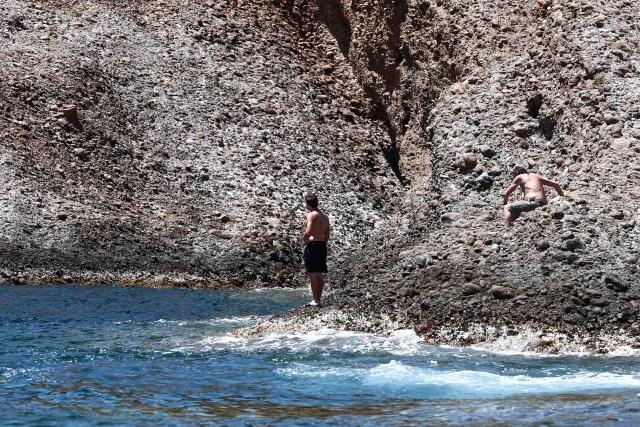 A beach goer enjoys the sunshine at "Anse du Sec" in La Ciotat, southeastern France on June 11, 2026. (Photo by Thibaud MORITZ / AFP)