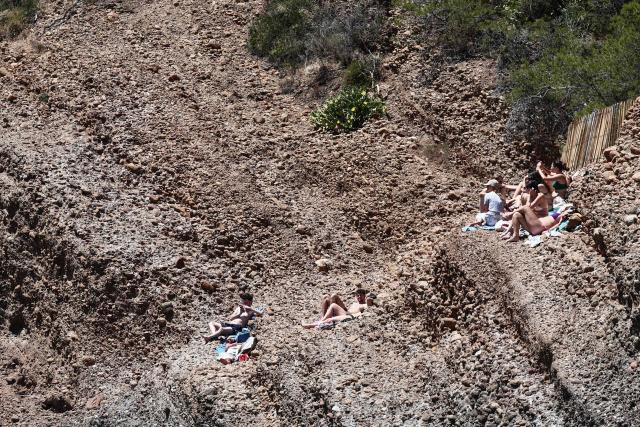 Beach goers enjoy the sunshine at "Anse du Sec" in La Ciotat, southeastern France on June 11, 2026. (Photo by Thibaud MORITZ / AFP)
