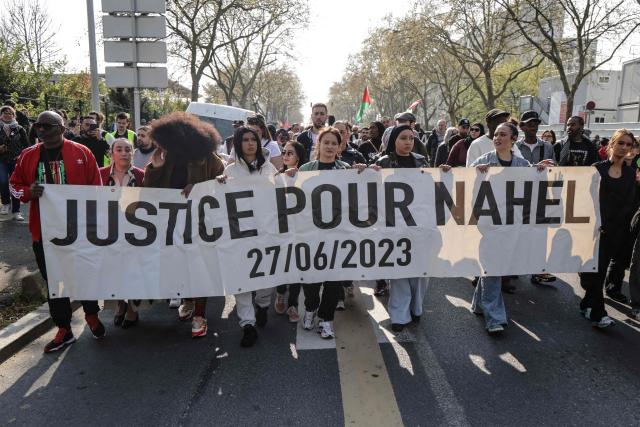 (FILES) Attendees carry a banner which reads "justice for Nahel" during a march in support of late French teenager Nahel and against Police impunity following the court's reclassification of the charges, in Nanterre, suburb of Paris on March 21, 2026. The Court of Cassation has overturned the reclassification of the charges against the police officer who fired the shot that killed Nahel Merzouk in June 2023, paving the way for a possible murder trial, according to the ruling seen by AFP on June 12, 2026. (Photo by Ludovic MARIN / AFP)