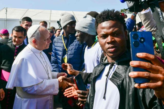 Pope Leo XIV greets migrants at the “Las Raices" (The Roots) centre in San Cristobal de la Laguna, outside Santa Cruz de Tenerife on the Canary Island of Tenerife on June 12, 2026. Pope Leo XIV is on the final day of a seven-day trip to Spain, including Barcelona and the islands of Gran Canaria and Tenerife where he will meet with migrants and organisations dedicated to helping them. (Photo by Stefano RELLANDINI / AFP)