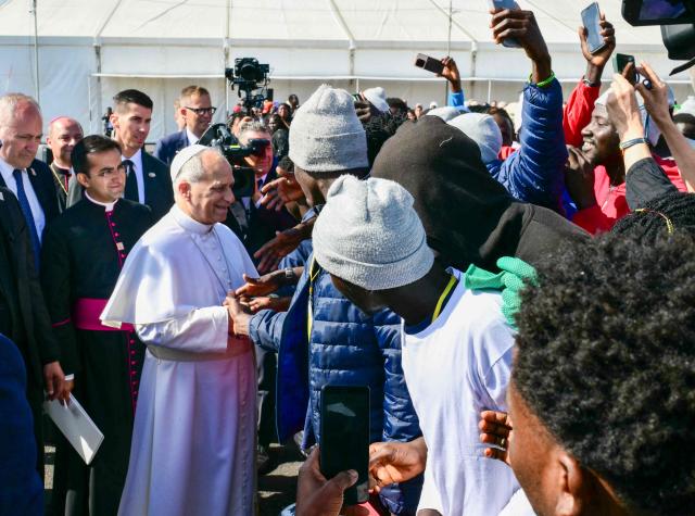 Pope Leo XIV greets migrants at the “Las Raices" (The Roots) centre in San Cristobal de la Laguna, outside Santa Cruz de Tenerife on the Canary Island of Tenerife on June 12, 2026. Pope Leo XIV is on the final day of a seven-day trip to Spain, including Barcelona and the islands of Gran Canaria and Tenerife where he will meet with migrants and organisations dedicated to helping them. (Photo by Stefano RELLANDINI / AFP)