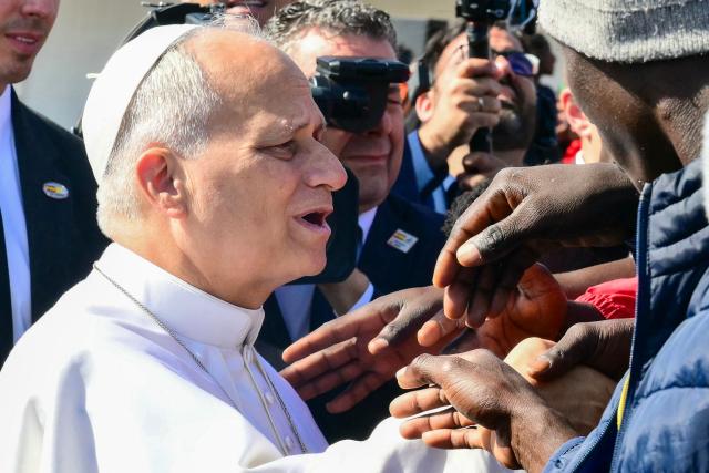 Pope Leo XIV greets migrants at the “Las Raices" (The Roots) centre in San Cristobal de la Laguna, outside Santa Cruz de Tenerife on the Canary Island of Tenerife on June 12, 2026. Pope Leo XIV is on the final day of a seven-day trip to Spain, including Barcelona and the islands of Gran Canaria and Tenerife where he will meet with migrants and organisations dedicated to helping them. (Photo by Stefano RELLANDINI / AFP)