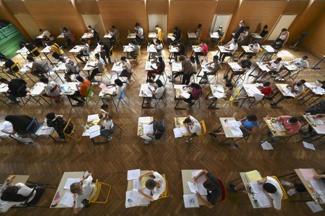 (FILES) High school students take the French exam, the first test session of the 2021 baccalaureate (high school graduation exam) on June 17, 2021 at the Pasteur high school in Strasbourg, eastern France. More than 700,000 candidates across France take the 2026 session of the Baccalaureat or "bac", the secondary school diploma required for access to higher education, with written exams running from June 15 to 18 and oral examinations through early July. (Photo by Frederick FLORIN / AFP)