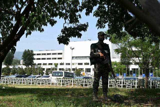 A Pakistani ranger stands guard outside of Parliament House in Islamabad on June 12, 2026, before the start of the budget session. (Photo by Farooq Naeem / AFP)