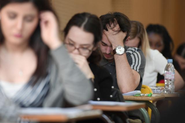 (FILES) High school students work on a 4 hours philosophy dissertation, that kicks off the French general baccalaureat exam for getting into university, on June 18, 2018 at the lycee Pasteur in Strasbourg, eastern France. More than 700,000 candidates across France take the 2026 session of the Baccalaureat or "bac", the secondary school diploma required for access to higher education, with written exams running from June 15 to 18 and oral examinations through early July. (Photo by Frederick FLORIN / AFP)