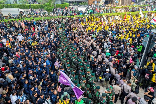 This aerial picture shows students protesting to demand a reduction in fuel prices and the dissolution of the free meal program, which they consider to be a hotbed of corruption, in Jakarta on June 12, 2026. (Photo by BAY ISMOYO / AFP)
