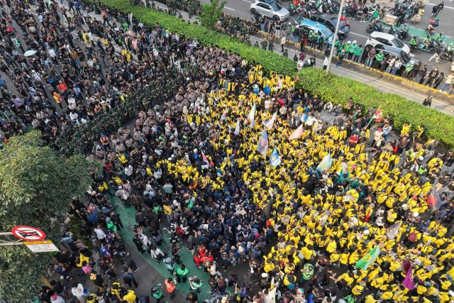 This aerial picture shows students protesting to demand a reduction in fuel prices and the dissolution of the free meal program, which they consider to be a hotbed of corruption, in Jakarta on June 12, 2026. (Photo by BAY ISMOYO / AFP)
