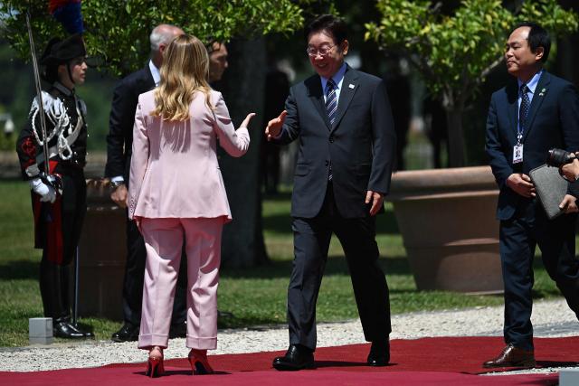 Italy's Prime Minister Giorgia Meloni (L) welcomes South Korean President Lee Jae Myung before a meeting at Villa Doria Pamphili in Rome on June 12, 2026. (Photo by Andreas SOLARO / AFP)