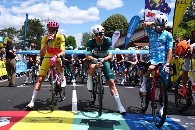 EF Education - EasyPost's French rider Alex Baudin wearing the overall leader's yellow jersey (L), NSN Cycling Team's Israeli rider Nadav Raisberg wearing the sprinter's green jersey (C) and Groupama-FDJ United's French rider Clément Braz Afonso wearing the climber's dotted jersey (R) await the start of the 6th stage of the Tour Auvergne-Rhone-Alpes cycling race (formerly known as the Criterium du Dauphine), 182,3km between Saint-Vulbas and Crest-Voland in the French Alps on June 12, 2026. (Photo by Anne-Christine POUJOULAT / AFP)