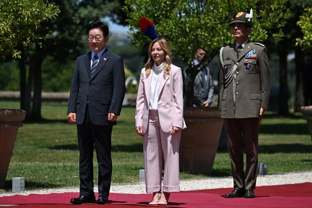 Italy's Prime Minister Giorgia Meloni (C) welcomes South Korea's President Lee Jae Myung (L) prior to a bilateral meeting at Villa Doria Pamphili, in Rome on June 12, 2026. (Photo by Andreas SOLARO / AFP)
