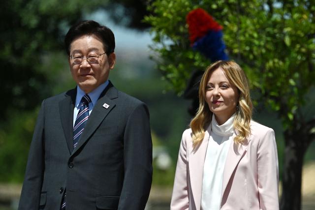 Italy's Prime Minister Giorgia Meloni (R) welcomes South Korea's President Lee Jae Myung prior to a bilateral meeting at Villa Doria Pamphili, in Rome on June 12, 2026. (Photo by Andreas SOLARO / AFP)