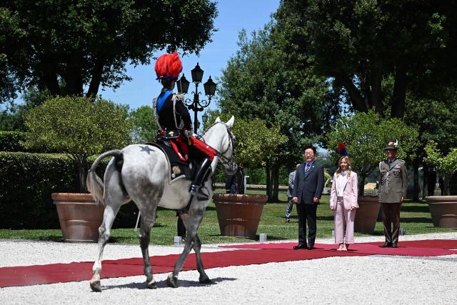 Italy's Prime Minister Giorgia Meloni (C) welcomes South Korea's President Lee Jae Myung (L) prior to a bilateral meeting at Villa Doria Pamphili, in Rome on June 12, 2026. (Photo by Andreas SOLARO / AFP)