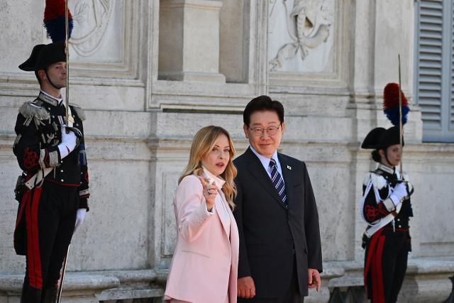 Italy's Prime Minister Giorgia Meloni (L) welcomes South Korea's President Lee Jae Myung prior to a bilateral meeting at Villa Doria Pamphili, in Rome on June 12, 2026. (Photo by Andreas SOLARO / AFP)
