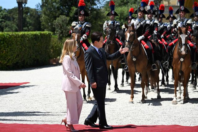 Italy's Prime Minister Giorgia Meloni (L)  welcomes South Korea's President Lee Jae Myung as they review the guards of honour, prior to a bilateral meeting at Villa Doria Pamphili, in Rome on June 12, 2026. (Photo by Andreas SOLARO / AFP)