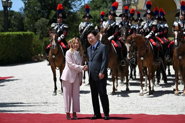 Italy's Prime Minister Giorgia Meloni (L) shakes hands as she welcomes South Korea's President Lee Jae Myung (R) prior to a bilateral meeting at Villa Doria Pamphili, in Rome on June 12, 2026. (Photo by Andreas SOLARO / AFP)