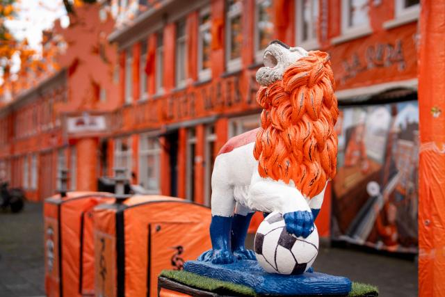 A lion statue wrapped in a Dutch national flag is displayed in the Marktweg street, decorated and renamed "Oranjestraat" (orange street) by its residents during the 2026 FIFA World Cup football tournament in The Hague on June 12, 2026. The Netherlands will open its 2026 FIFA World Cup Group F campaign co-hosted by the United States, Mexico and Canada, against Japan at the AT&T Stadium in Arlington on June 14, 2026. (Photo by Lina Selg / AFP)