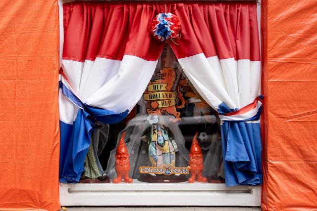 This photograph shows a window bearing curtains in the colors of the flag of the Netherlands in the Marktweg street, decorated and renamed "Oranjestraat" (orange street) by its residents during the 2026 FIFA World Cup football tournament in The Hague on June 12, 2026. The Netherlands will open its 2026 FIFA World Cup Group F campaign co-hosted by the United States, Mexico and Canada, against Japan at the AT&T Stadium in Arlington on June 14, 2026. (Photo by Lina Selg / AFP)