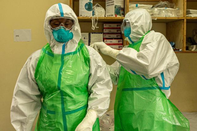 Two nurses in their Personal Protection Equipment (PPE) prepare to receive a patient with a highly infectious disease such as Ebola, during a simulation exercise at the special isolation ward of the department of Infectious Diseases Unit (IDU) at the the Kenyatta National hospital in Nairobi on June 12, 2026. (Photo by SIMON MAINA / AFP)