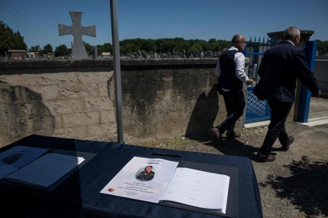 A photograph taken on June 12, 2026 shows a stand displaying a book of condolences at the entrance of the cemetery in Fleurance, south western France, where the funeral of 11-year-old girl Lyhanna is due to take place later today. The body of Lyhanna was found last week after she went missing on May 29 in the southwestern town of Fleurance. The suspect, a 41-year-old father of a school friend of the victim, had twice before been formally accused of raping a child, but investigations had been dropped or had stalled. (Photo by Ed JONES / AFP)