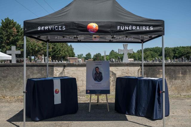 A photograph taken on June 12, 2026 shows a stand displaying a book of condolences at the entrance of the cemetery in Fleurance, south western France, where the funeral of 11-year-old girl Lyhanna is due to take place later today. The body of Lyhanna was found last week after she went missing on May 29 in the southwestern town of Fleurance. The suspect, a 41-year-old father of a school friend of the victim, had twice before been formally accused of raping a child, but investigations had been dropped or had stalled. (Photo by Ed JONES / AFP)