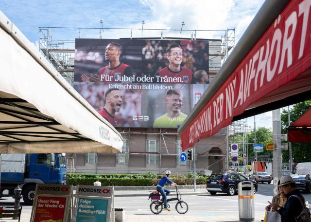 A large billboard shows players of Austrian national football team currently representing Austria at FIFA World Cup 2026 co-hosted by the United States is displayed at Naschmarkt market in Vienna, Austria, on June 12, 2026. (Photo by Joe Klamar / AFP)