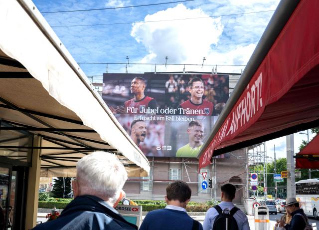 A large billboard shows players of Austrian national football team currently representing Austria at FIFA World Cup 2026 co-hosted by the United States is displayed at Naschmarkt market in Vienna, Austria, on June 12, 2026. (Photo by Joe Klamar / AFP)