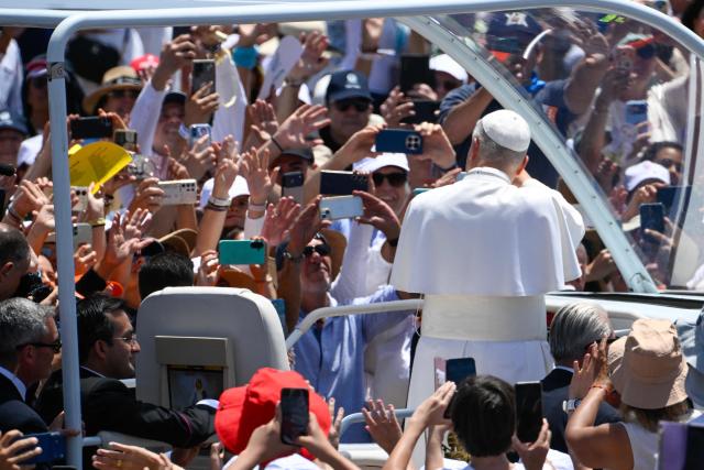 Pope Leo XIV waves from the popmobile as he arrives to lead a Holy mass at the port of Santa Cruz de Tenerife, on the Canary Island of Tenerife on June 12, 2026. Pope Leo XIV is on the final day of a seven-day trip to Spain, including Madrid, Barcelona and the islands of Gran Canaria and Tenerife where he met with migrants and organisations dedicated to helping them. (Photo by Miguel RIOPA / AFP)
