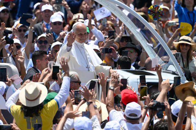Pope Leo XIV waves from the popmobile as he arrives to lead a Holy mass at the port of Santa Cruz de Tenerife, on the Canary Island of Tenerife on June 12, 2026. Pope Leo XIV is on the final day of a seven-day trip to Spain, including Madrid, Barcelona and the islands of Gran Canaria and Tenerife where he met with migrants and organisations dedicated to helping them. (Photo by Miguel RIOPA / AFP)