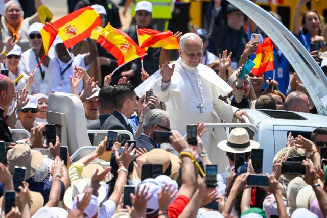 Pope Leo XIV waves from the popmobile as he arrives to lead a Holy mass at the port of Santa Cruz de Tenerife, on the Canary Island of Tenerife on June 12, 2026. Pope Leo XIV is on the final day of a seven-day trip to Spain, including Madrid, Barcelona and the islands of Gran Canaria and Tenerife where he met with migrants and organisations dedicated to helping them. (Photo by Miguel RIOPA / AFP)