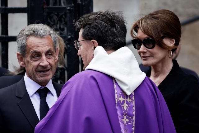 France's former president Nicolas Sarkozy (L) and his wife French Italian singer and model Carla Bruni (R) arrive to attend the funeral ceremony for late Bernadette Chirac, widow of former French president Jacques Chirac at the Basilica Sainte-Clotilde, in Paris on June 12, 2026. Bernadette Chirac passed away at 93 years old on June 5. She stood by her late husband, former French president Jacques Chirac, during 12 years as first lady, but also forged her own, more discreet, political career. (Photo by STEPHANE DE SAKUTIN / AFP)