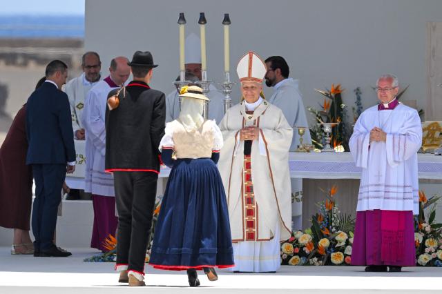 Pope Leo XIV receives faithful in traditional dress during a Holy mass at the port of Santa Cruz de Tenerife, on the Canary Island of Tenerife on June 12, 2026. Pope Leo XIV is on the final day of a seven-day trip to Spain, including Madrid, Barcelona and the islands of Gran Canaria and Tenerife where he met with migrants and organisations dedicated to helping them. (Photo by JORGE GUERRERO / AFP)