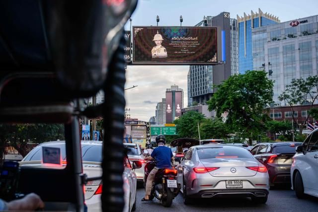 A digital display mourning the death of Thai Princess Bajrakitiyabha Mahidol is seen above a road during the evening rush hour in Bangkok on June 12, 2026. Thai Princess Bajrakitiyabha Mahidol, the king's eldest daughter, has died aged 47, the royal palace announced on June 12, more than three years after she was hospitalised following a sudden illness. (Photo by ANTHONY WALLACE / AFP)