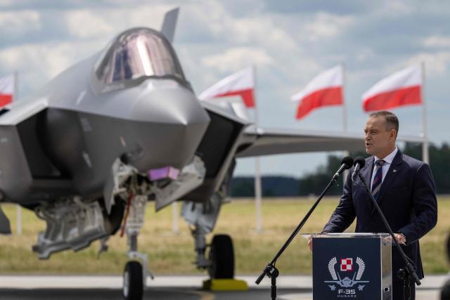 Poland's President Karol Nawrocki speaks during the ceremony for the official entry into service with the Polish Air Force of the first tree US-made F-35 aircrafts (Polish codename Husarz) on June 12, 2026, at the 32nd Tactical Air Base in Lask, central Poland. (Photo by Wojtek RADWANSKI / AFP)