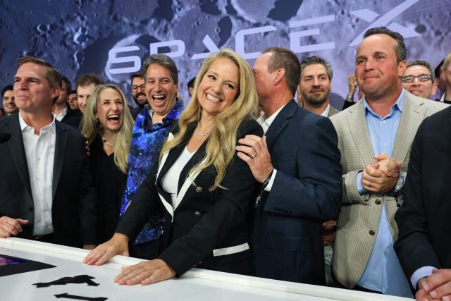 Gwynne Shotwell (c), SpaceX President and Chief Operating Officer, celebrates with SpaceX employees and executives after they rang the opening bell at the Nasdaq MarketSite to celebrate the launch of SpaceXs initial public offering (IPO) in New York on June 12, 2026. Elon Musk's SpaceX begins trading on the Nasdaq exchange on Friday with the biggest initial public offering in history expected to make the polarizing entrepreneur the world's first trillionaire. The company priced more than 555 million shares at $135 each in a filing with the US markets regulator on Thursday, placing SpaceX in the top 10 of Wall Street's biggest companies with a valuation of just under $1.8 trillion -- ahead of Tesla, Facebook-owner Meta and Walmart. (Photo by TIMOTHY A. CLARY / AFP)