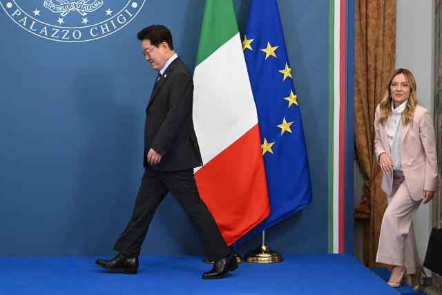 Italy's Prime Minister Giorgia Meloni (R) and South Korea's President Lee Jae Myung (L) arrive to pose for pictures following their bilateral meeting of the Agreements of Understanding on development cooperation in the fields of science, advanced technologies, information and communication technologies in the sector of micro, small and medium-sized enterprises, at Villa Doria Pamphili, in Rome on June 12, 2026. (Photo by Andreas SOLARO / AFP)