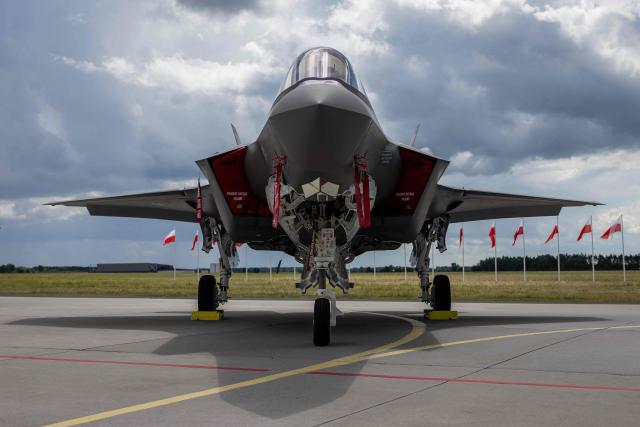 US-made F-35 aircraft (Polish codename Husarz) of the Polish Air Force is seen parked on the tarmac at the 32nd Tactical Air Base in Lask, central Poland, on June 12, 2026, on the day of their official entry into service with the Polish Air Force. (Photo by Wojtek RADWANSKI / AFP)