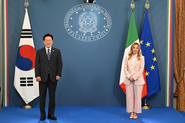 Italy's Prime Minister Giorgia Meloni (R) and South Korea's President Lee Jae Myung (L) pose for pictures following their bilateral meeting of the Agreements of Understanding on development cooperation in the fields of science, advanced technologies, information and communication technologies in the sector of micro, small and medium-sized enterprises, at Villa Doria Pamphili, in Rome on June 12, 2026. (Photo by Andreas SOLARO / AFP)