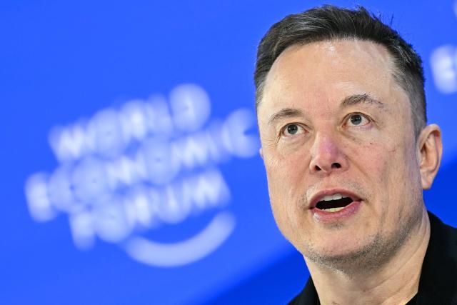 (FILES) CEO of SpaceX and Tesla, South African-Canadian-US businessman Elon Musk speaks during the World Economic Forum (WEF) annual meeting in Davos on January 22, 2026. Elon Musk's SpaceX began its first day as a public company on Wall Street on June 12, 2026, after the biggest initial public offering in history, with the polarizing entrepreneur promising he will take humanity to Mars. The blockbuster operation, which raised more than $75 billion, is expected to make Musk the world's first trillionaire and kick off a series of major IPOs by AI companies in the coming months. (Photo by Fabrice COFFRINI / AFP)