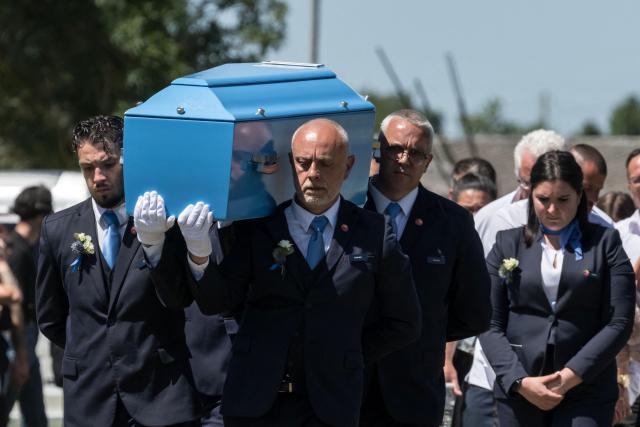 Pallbearers carry the coffin during the funeral ceremony of 11-year-old girl Lyhanna, in Fleurance, south western France on June 12, 2026. The body of Lyhanna was found last week after she went missing on May 29 in the southwestern town of Fleurance. The suspect, a 41-year-old father of a school friend of the victim, had twice before been formally accused of raping a child, but investigations had been dropped or had stalled. (Photo by Ed JONES / AFP)