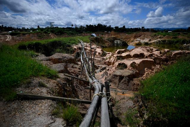 A view shows pipes used in an artisanal gold mine at Las Brisas de Cuyuni, near the town of Las Claritas in Bolivar state, Venezuela, on June 11, 2026. Venezuela, home to the world's largest oil reserves, also has deposits of gold, diamonds, bauxite, coltan and rare earths, but much of its mining areas — notably the 112,000 sq km Mining Arc located in remote regions far from major cities — is controlled by armed gangs or guerrilla groups. (Photo by Federico PARRA / AFP)